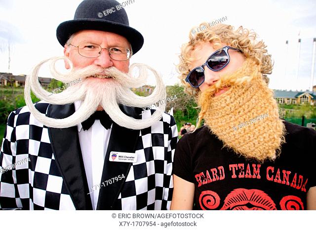 Willi Chevalier a competitor at the 2010 USA National Beard and Moustache Championships with a young woman in a fake beard, in Bend, OR, USA  June 5, 2010