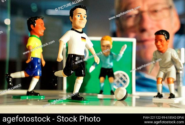 22 November 2022, Saxony, Chemnitz: Hans-Peter Hock, collector, soccer fan and sports historian, sits behind a display case of figurines from the tabletop...