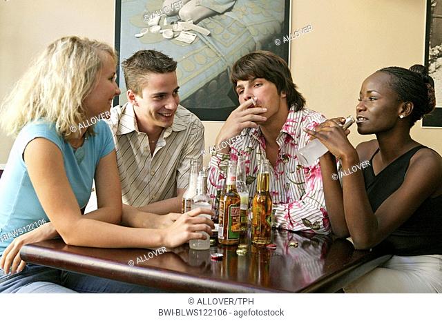 young people drinking alcohol at a pub