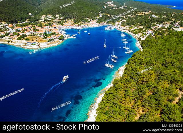 Beautiful Fiscardo village at Kefalonia island. Port with yacht boats and a ferry