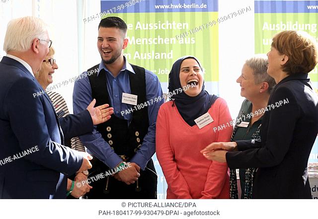 17 April 2018, Berlin, Germany: German President Frank-Walter Steinmeier (L) and his wife Elke Buedenbender (R) talk to trainees Kawthar Khalil (3-R) and Marwan...
