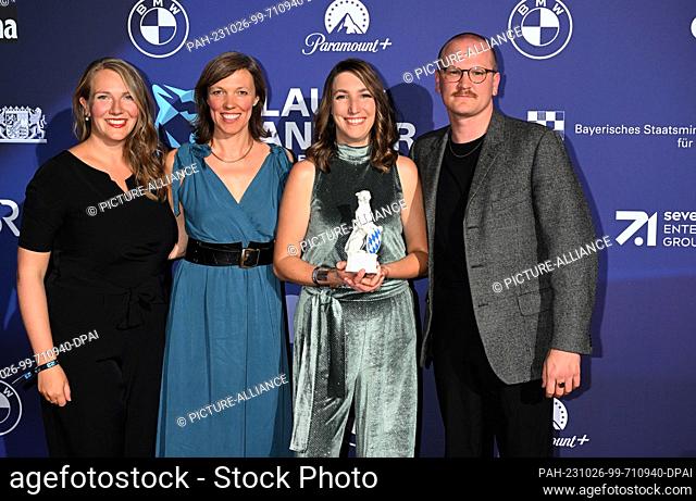 25 October 2023, Bavaria, Munich: Journalist Julia Schweinberger (3rd from left) stands on the red carpet at the BMW Welt with her Blue Panther in the...