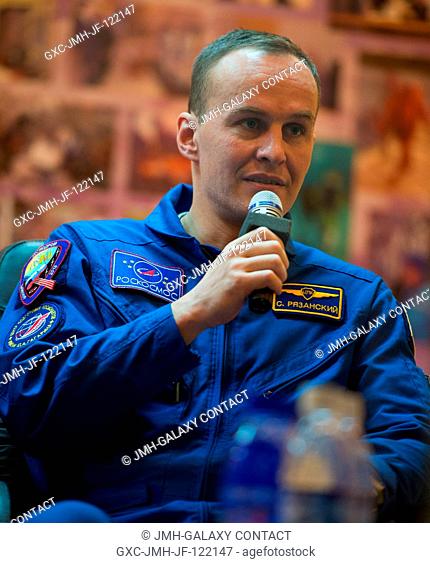 Expedition 35 backup crew member Sergei Ryazanski talks during an Expedition 35 crew press conference held ahead of the planned launch of the Soyuz with...
