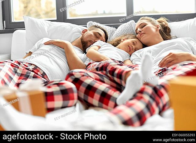 happy family sleeping in bed on christmas morning