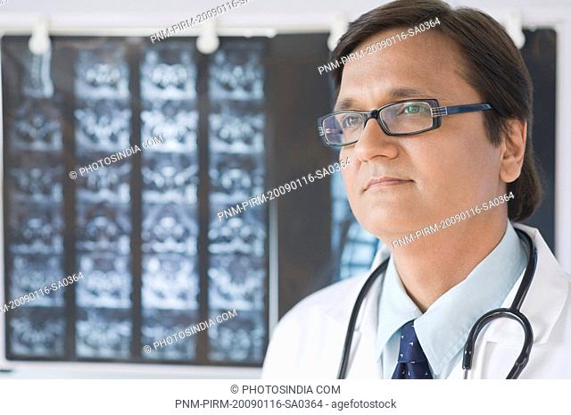 Close-up of a doctor thinking, Gurgaon, Haryana, India