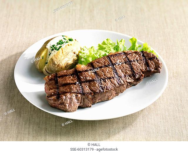 Grilled beef tenderloin, baked potatoes with cream and chives