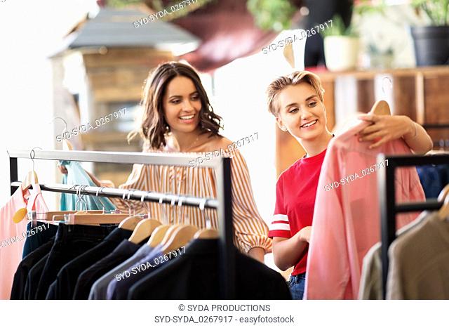 women choosing clothes at vintage clothing store