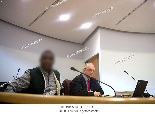 The defedant (L) in a trial concerning suspected support for an overaseas terrorist network sits with his lawyer Guenter Urbanczyk in room 18 of regional court...