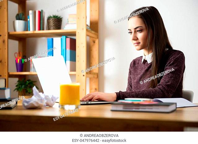 Attractive caucasian girl studying for her exams at home