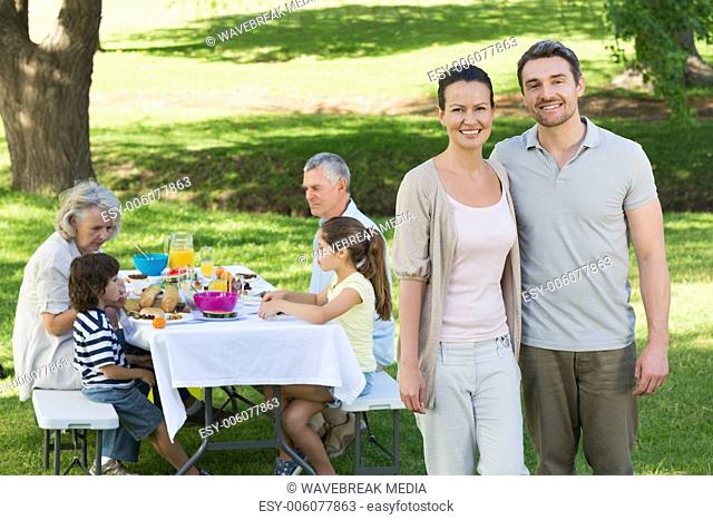 Couple with family having lunch in the lawn