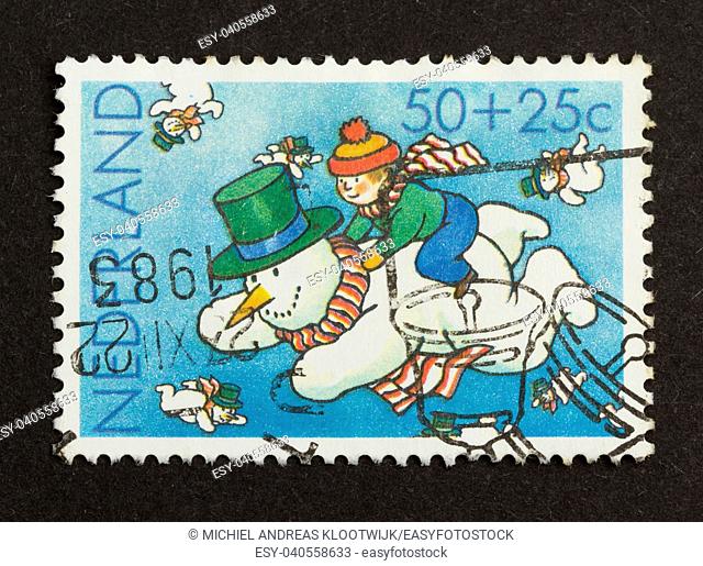 HOLLAND - CIRCA 1980: Stamp printed in the Netherlands shows a flying snowman, circa 1980