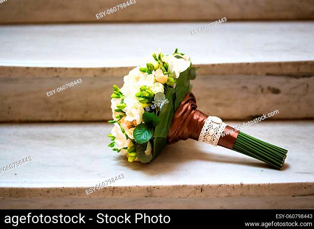 beautiful wedding bouquet on the marble staircase