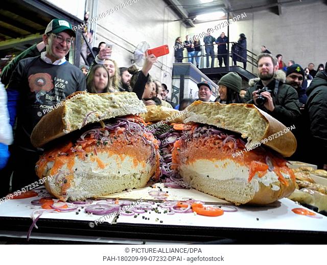 Employees of the fish smokehouse Acme Smoked Fish and the bagel manufacturer Zucker's Bagel & Smoked Fish building an overdimensional salmon bagel with cream...