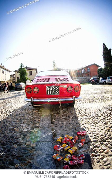 vintage red car, fiat 850 sport coupè, churchyard of varallo pombia, piedmont Italy