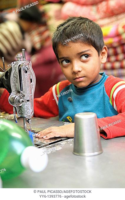 child labourer, young boy sewing , the nepalis , life in kathmandu , kathmandu street life , nepal