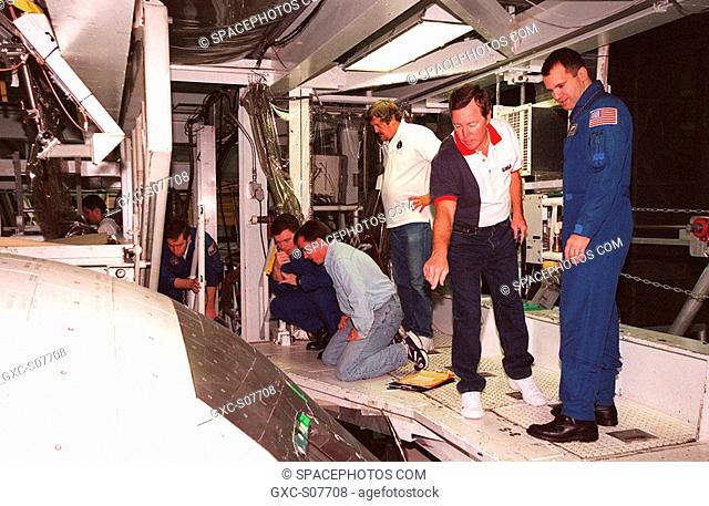 01/13/2001 --- Members of the STS-102 crew and workers in the Orbiter Processing Facility bay 1 look over the windows of the orbiter Discovery