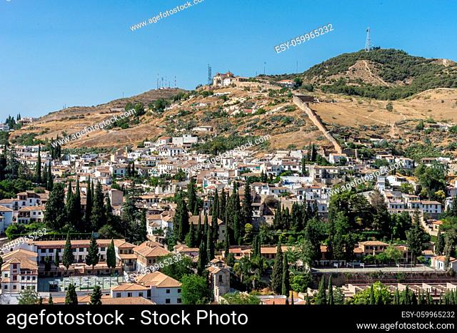 Hillside view of the city of Granada, Albaycin , viewed from the Alhambra palace in Granada, Spain, Europe on a bright summer day with blue sky