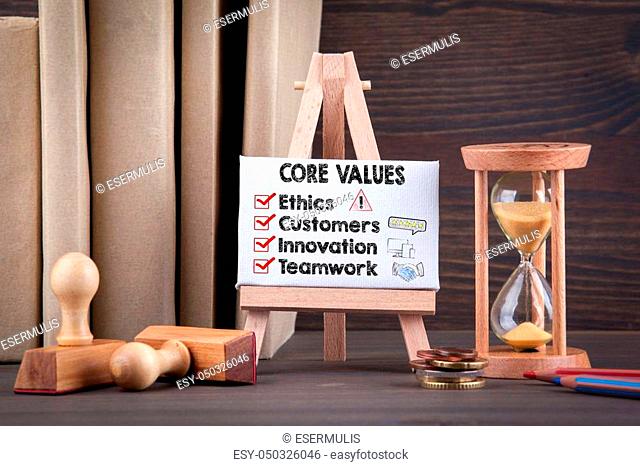 Core Values concept with icons. Sandglass, hourglass or egg timer on wooden table showing the last second or last minute or time out