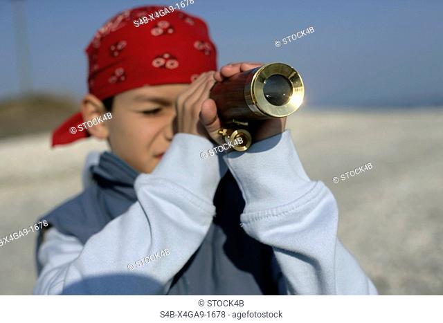 Boy looking through a telescope