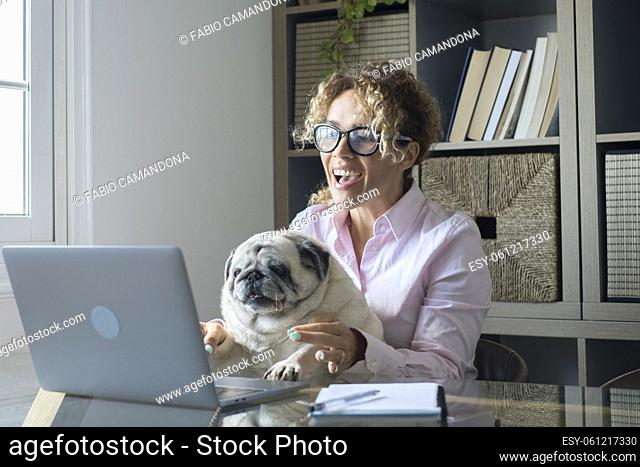 People working at home with internet connection and laptop computer - funny scene with cheerful female people in video call conference and playful cute pug dog...