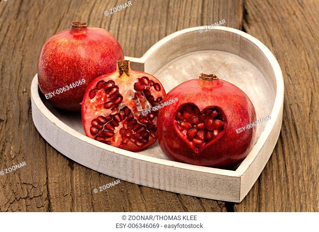 Two whole and one half pomegranate