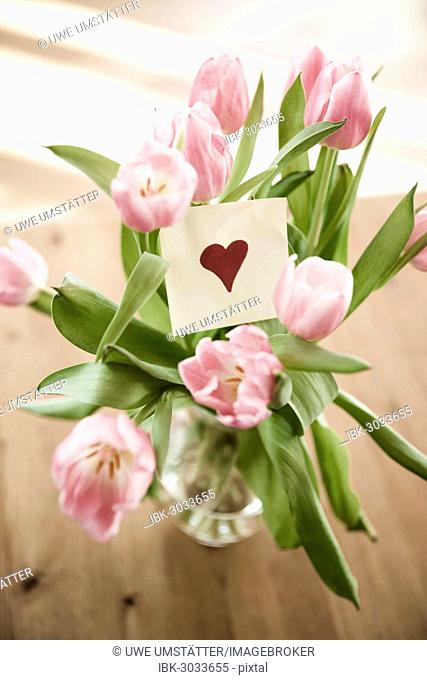 Tulips in vase, paper note with a heart, Mannheim, Baden-Württemberg, Germany