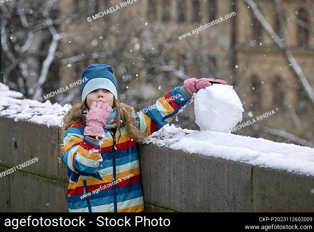 A girl with a snowball is seen on the Charles Bridge in Prague, Czech Republic, on November 26, 2023. (CTK Photo/Michaela Rihova)
