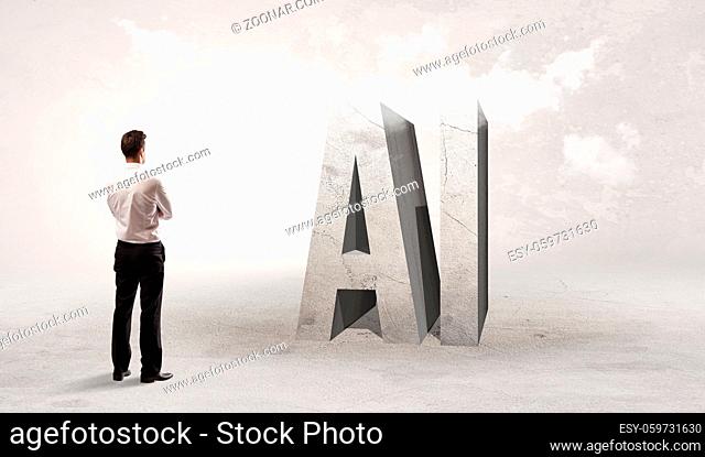 Rear view of a businessman standing in front of AI abbreviation, attention making concept