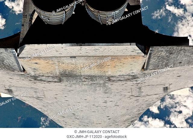 This view of the aft underside of the space shuttle Discovery was provided by an Expedition 26 crew member during a survey of the approaching STS-133 vehicle...