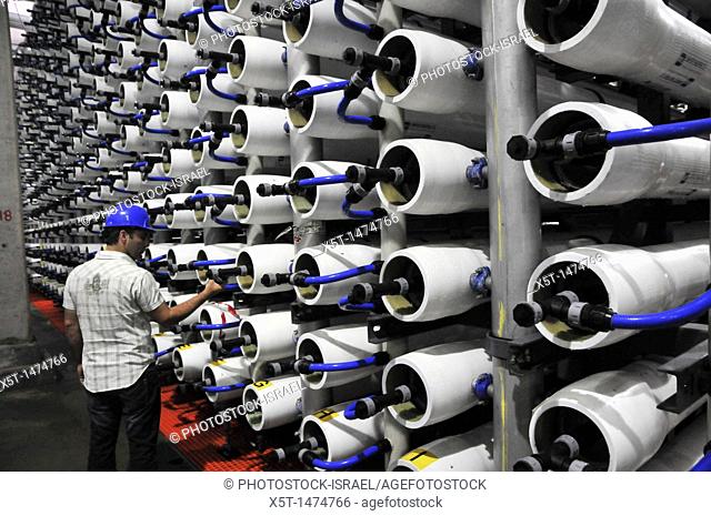 Desalination plant  Engineer inspects the Reverse Osmosis membrane filters  This facility turns salt water into drinking water using the Reverse Osmosis Process...