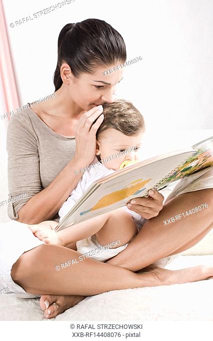 Mother reading book for baby