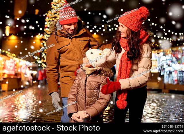 happy family at christmas market in city