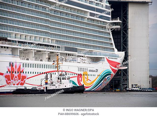 After being undocked the 334-meter-long cruise ship 'Norwegian Joy' is brought to the equipment pier of of the Meyer shipyard in Papenburg, Germany