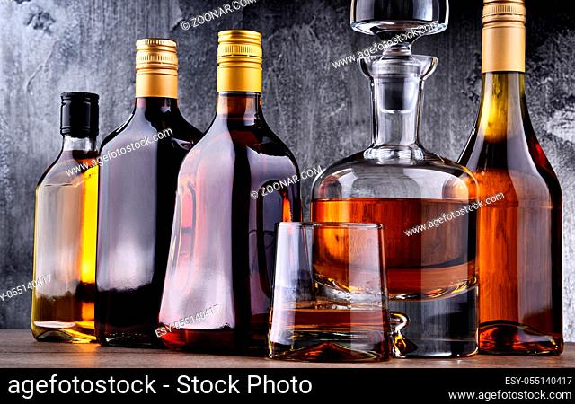 Composition with carafe and bottles of assorted alcoholic beverages