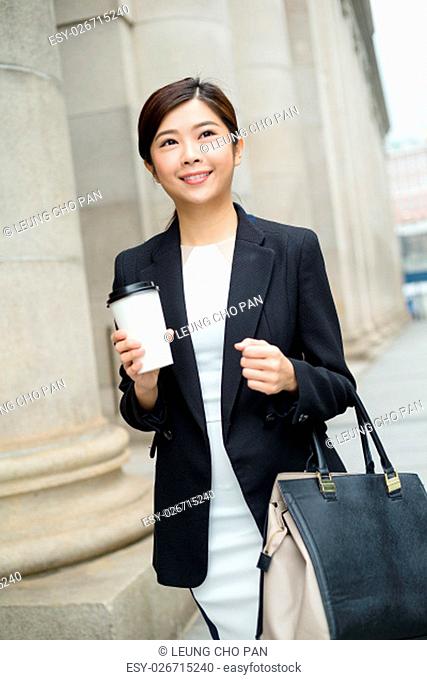 Business woman walking and hold with coffee