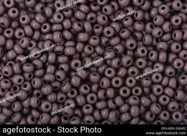 Gray Beads on the white background. Background or texture of beads. Close up, macro, It is used in finishing fashion clothes