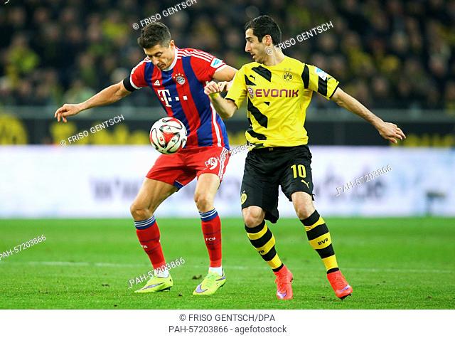 Dortmund's Henrikh Mkhitaryan (R) and Munich's Robert Lewandowski (l) compete for the ball during the German Bundesliga soccer match between Borussia Dortmund...