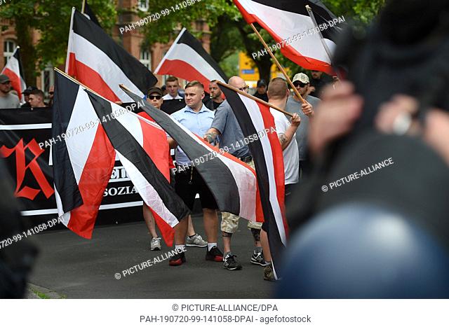 20 July 2019, Hessen, Kassel: Supporters of the small party ""The Right"" start their demonstration with flags. Around 10