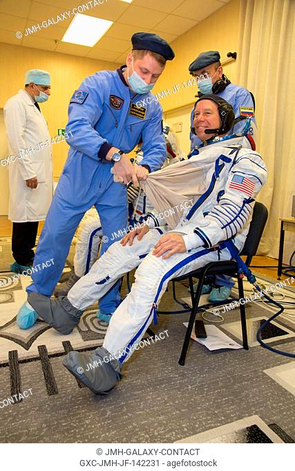 In the Integration Facility at the Baikonur Cosmodrome in Kazakhstan, Expedition 46-47 crewmember Tim Kopra of NASA suits up during a fit check dress rehearsal...