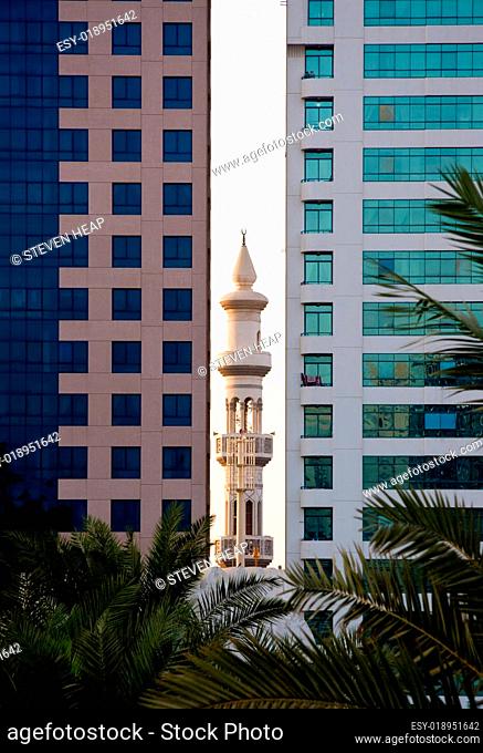 Minaret peeping between office buildings