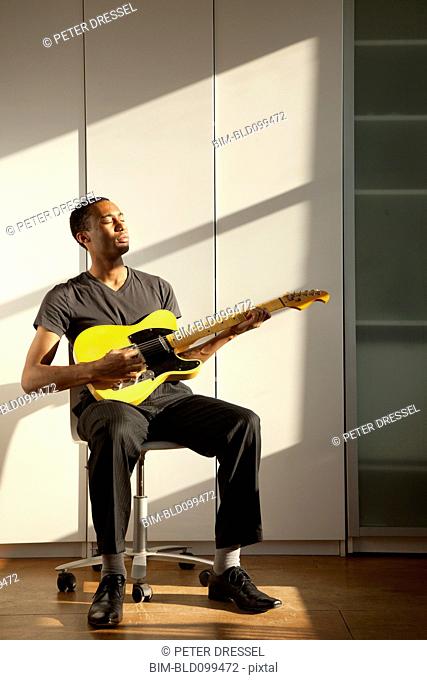 Black man playing guitar