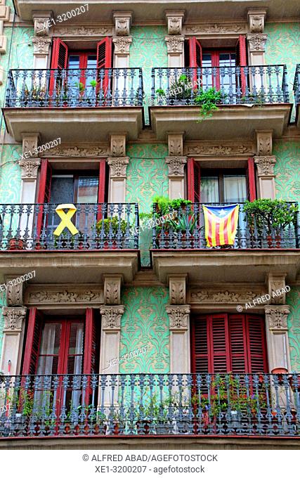 Yellow ribbon and estelada (pro-independence flag) in modernist building balcony, Poble Sec district, Barcelona, Catalonia, Spain