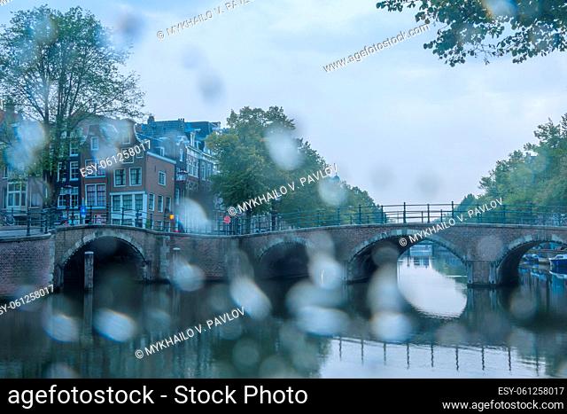 Netherlands. Summer morning on the Amsterdam canal. Rainy weather drowned out all the colors