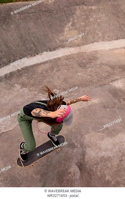 Woman skateboarding in skateboard park