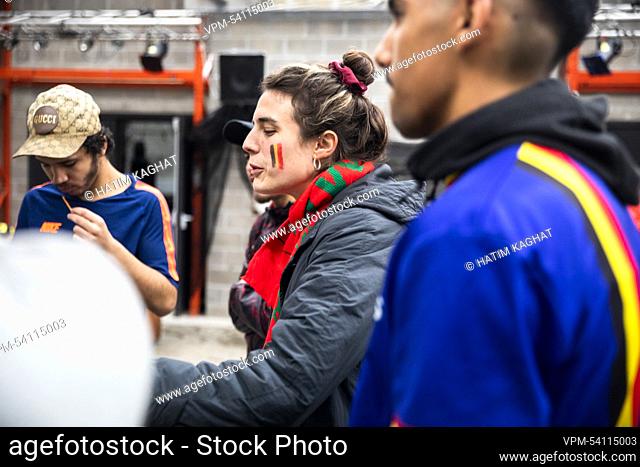Illustration picture shows a woman with the colours of the Belgian flag on her cheeks, and wearing a scarf of Morocco, as supporters gather to watch a soccer...