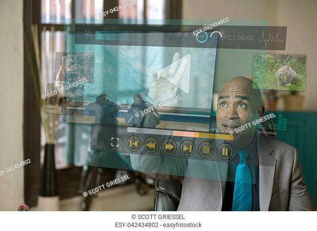 Professional man watching a futuristic video screen