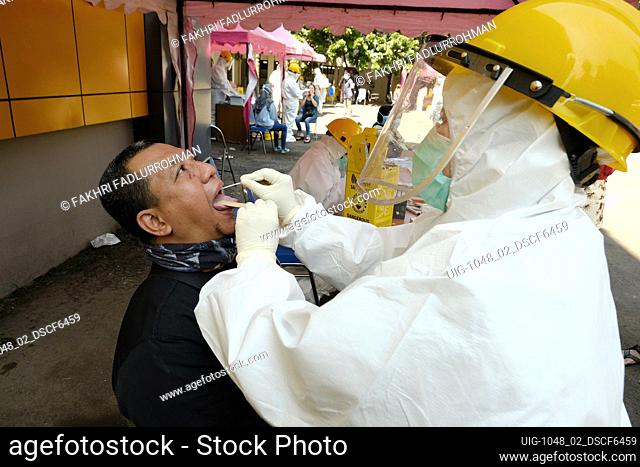 A health worker wearing protective suit as a preventive measure during collects swab samples in Bandung, West Java, Indonesia, May 16, 2020