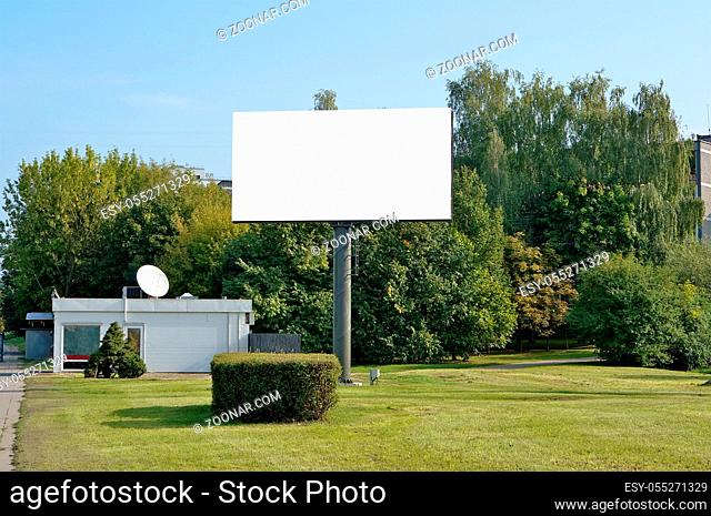 The urban metal mass production empty billboard for outdoor modern LED advertizing. Sunny summer urban day landscape