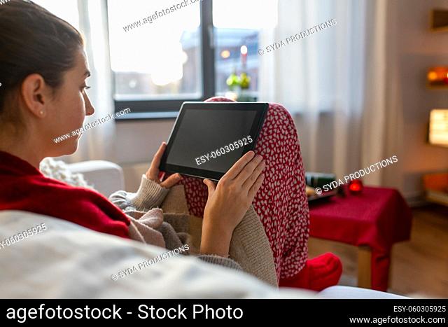 woman with tablet computer at home on christmas