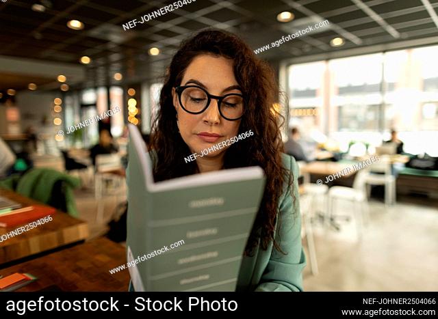 Businesswoman checking diary in cafe